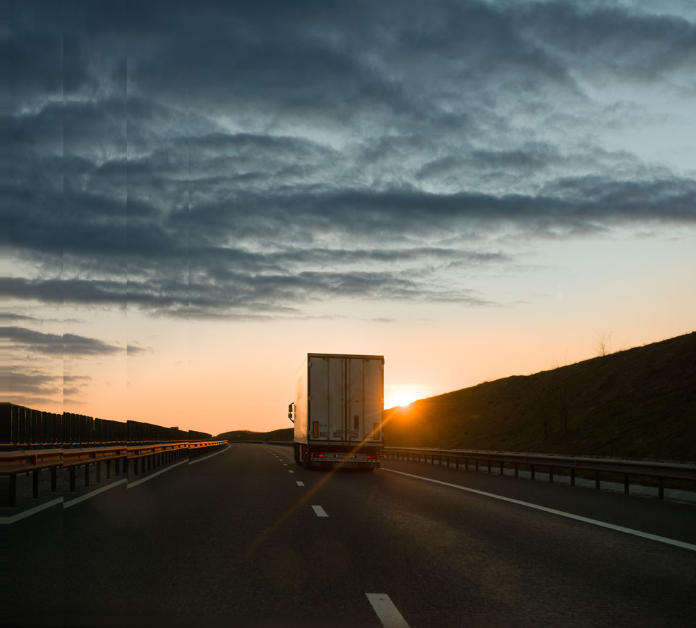 Logistics truck on highway at sunset